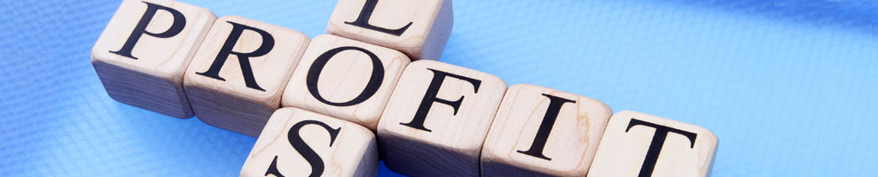 Wooden letter tiles spelling PROFIT and LOSS